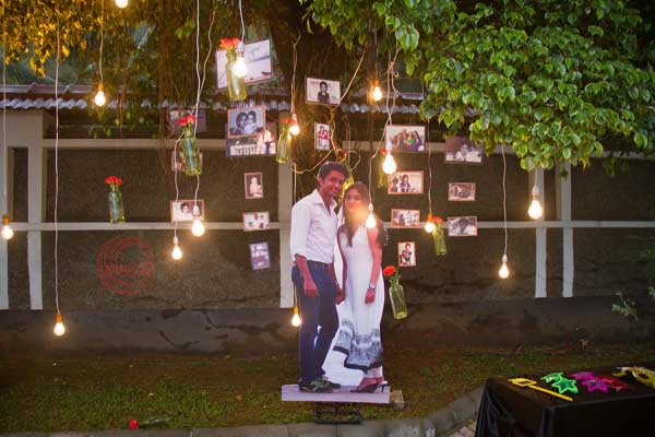 photo booth with hanging lanterns and photos 